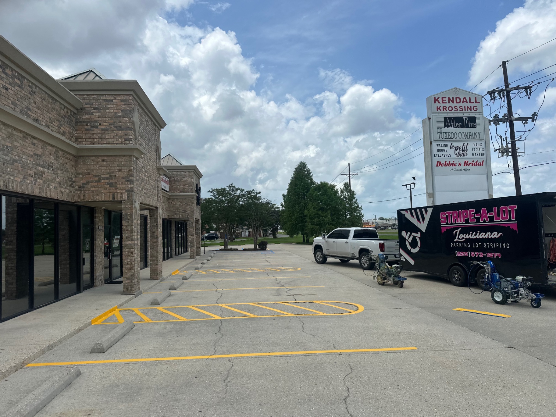 Fresh yellow curbside parking markings at Kendall Krossing